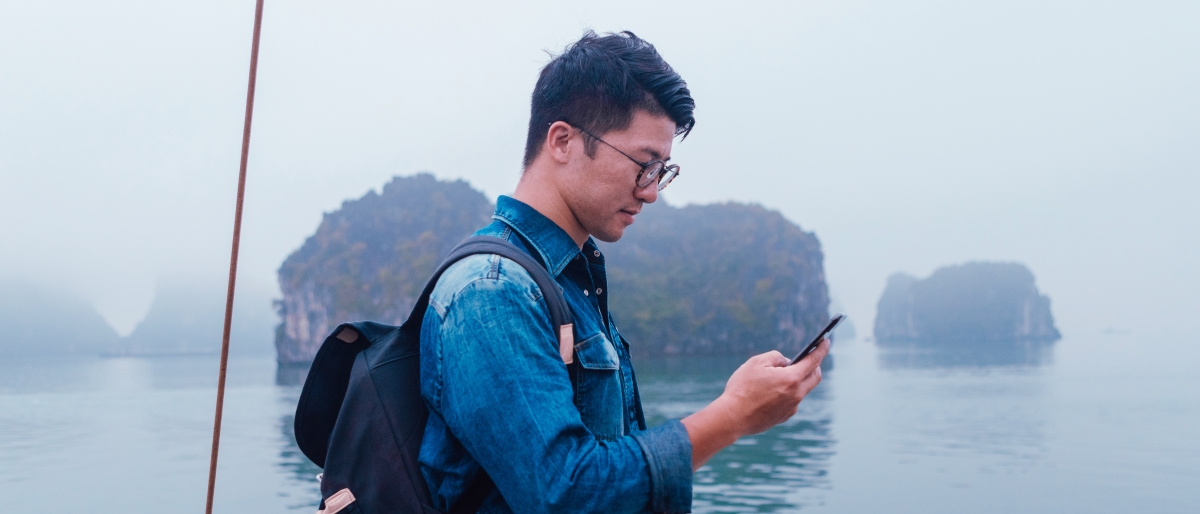 Image of a Person using a phone on a ship.