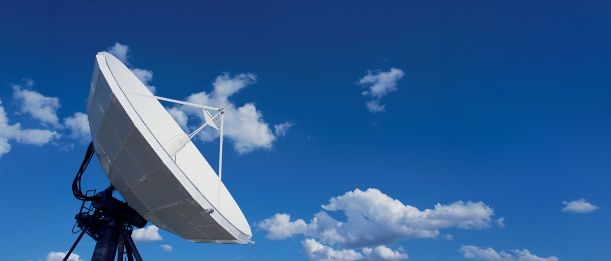 Image of an antenna dish setup with clouds in the background