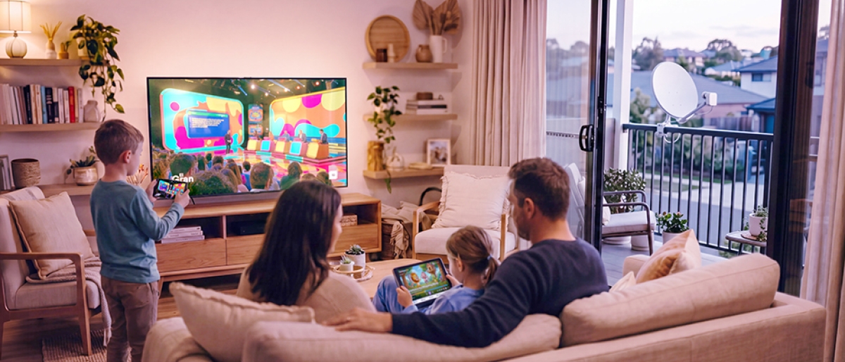 Family sitting on the couch watching television