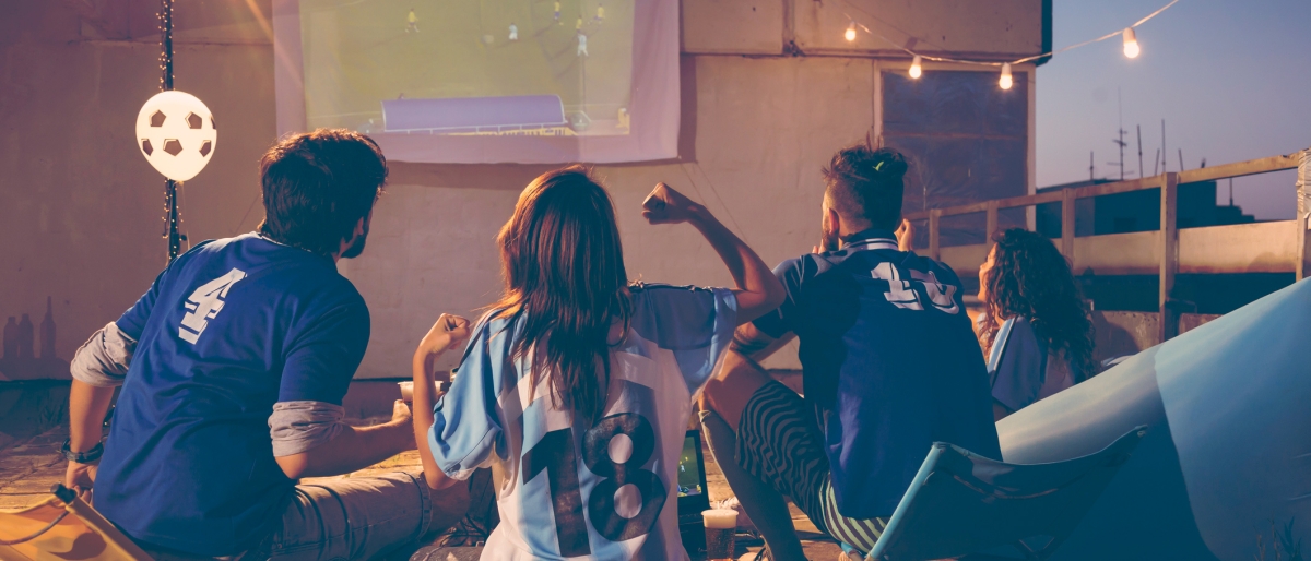 Group of people enjoying watching sports on a terrace