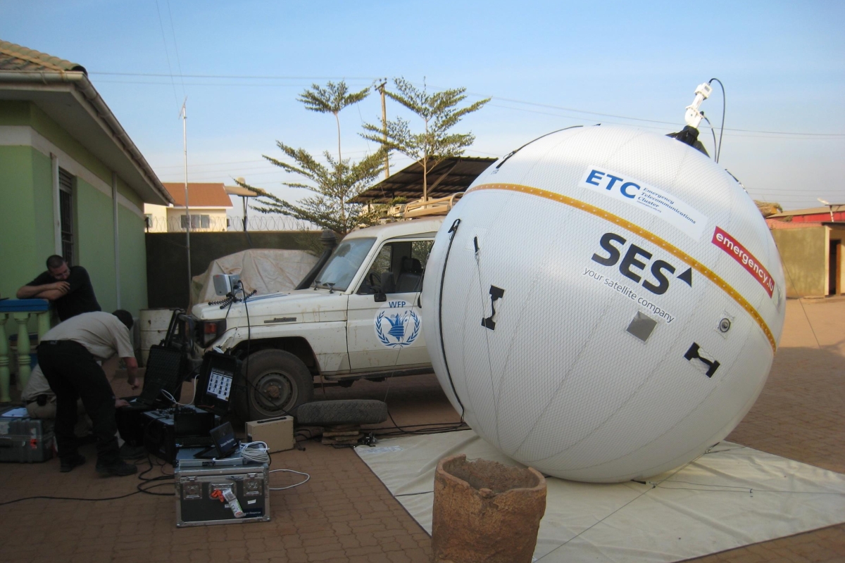 Inflatable satellite next to car and equipment 