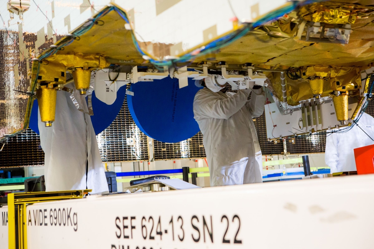 group of engineers wearing suit working on satellite components
