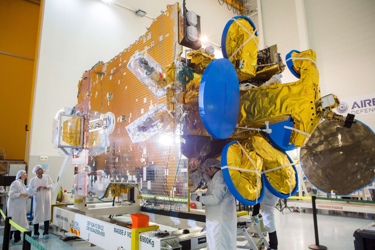 Engineers working on satellite bus 