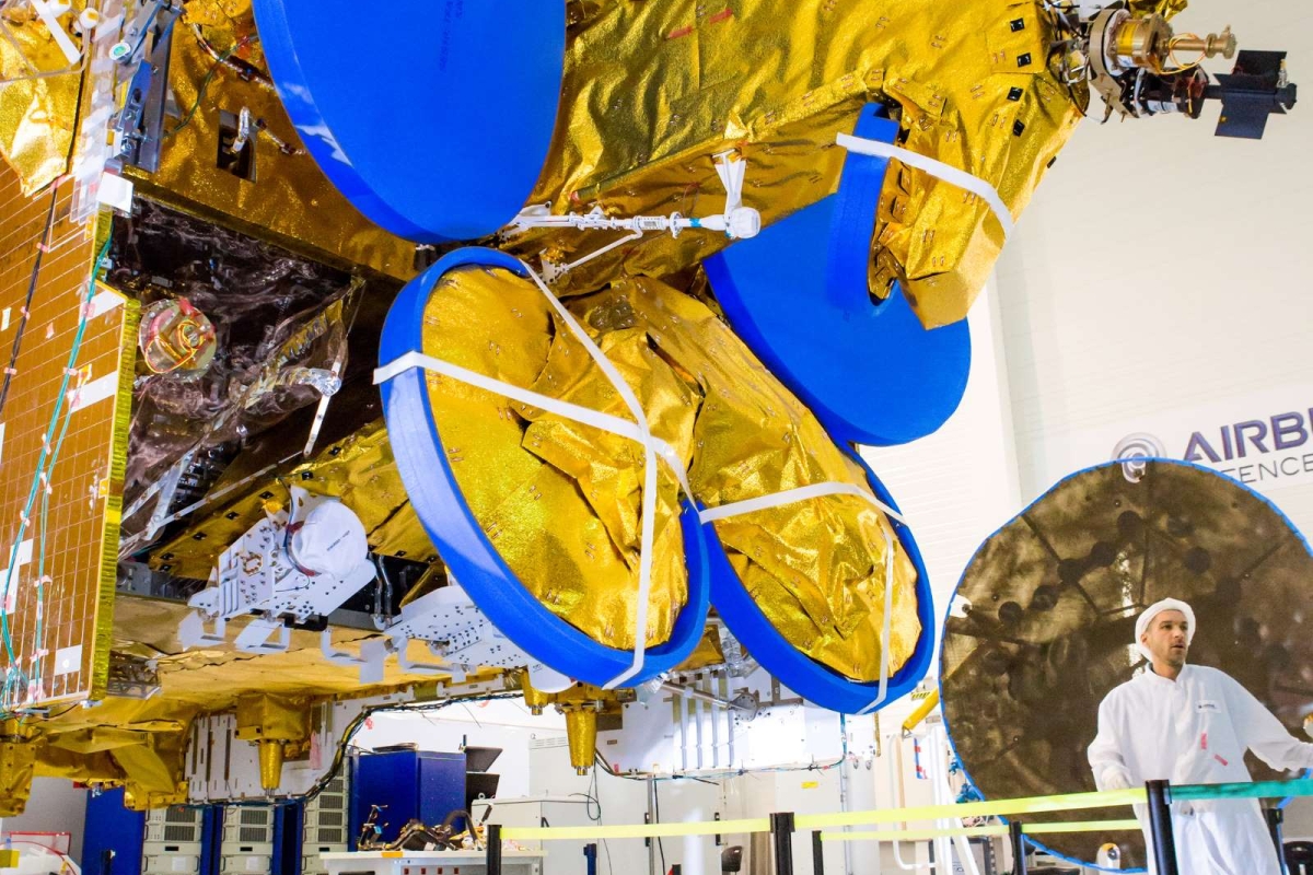 Satellite bus with blue components placed on mechanical ground support equipment 