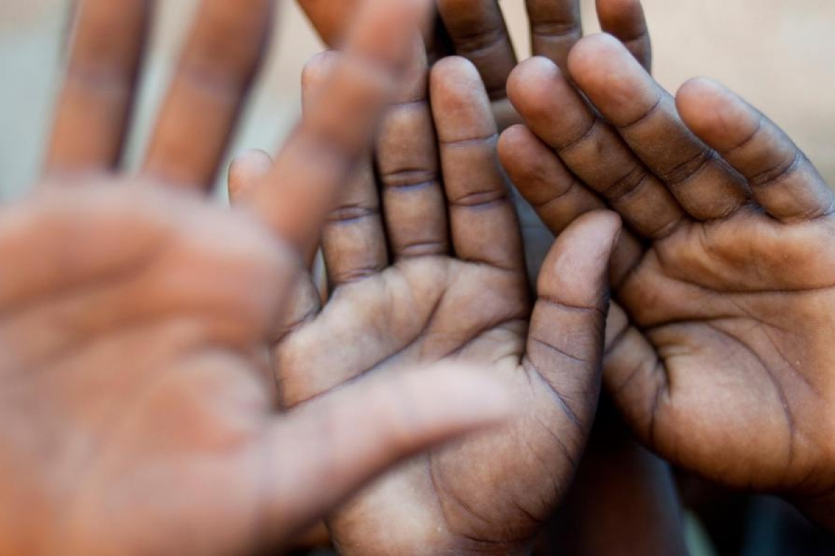 Close‑up image of children’s open palms.