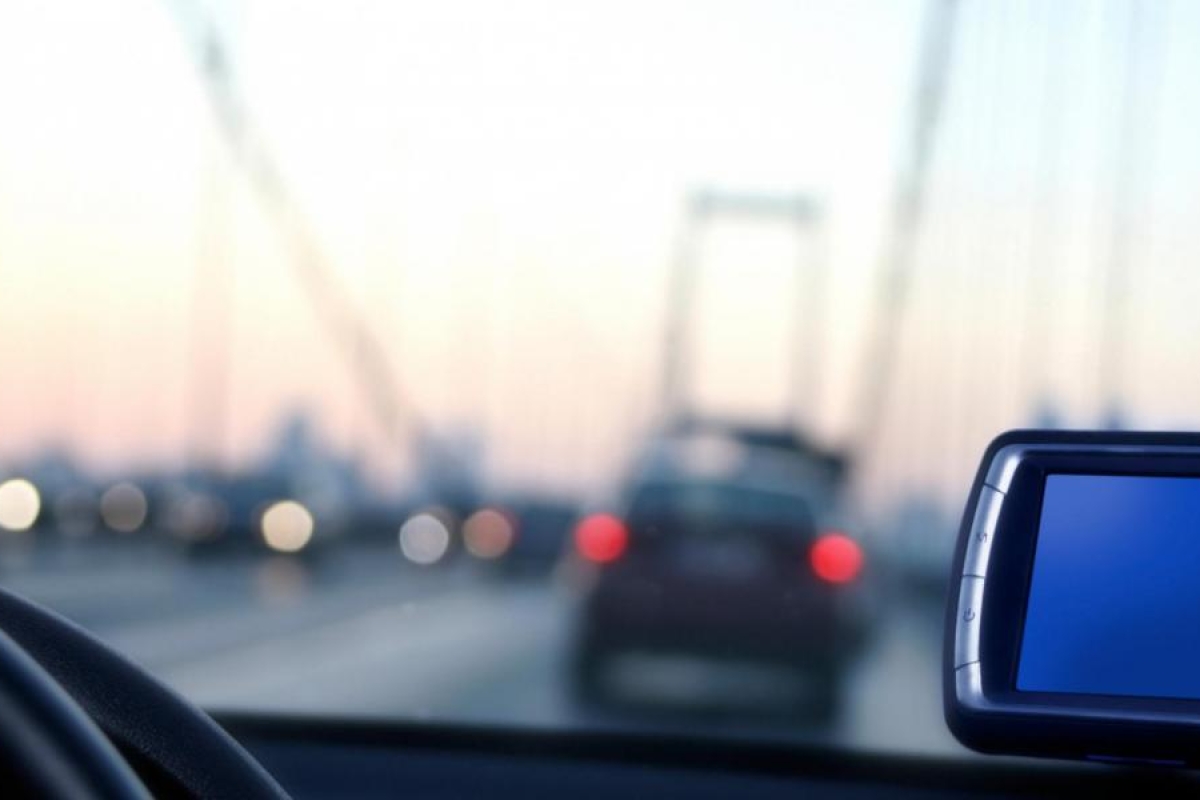 Image of car dashboard view on a bridge at dusk.