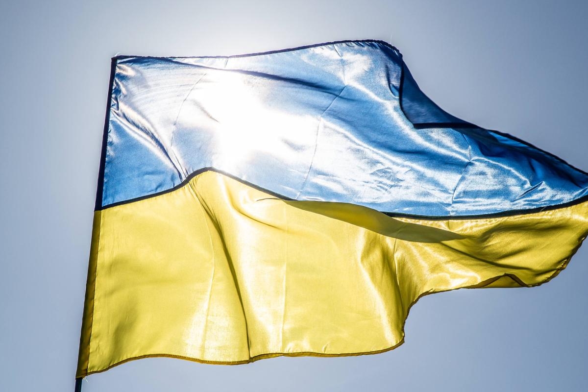 Image of Ukrainian flag waving in the sunlight.