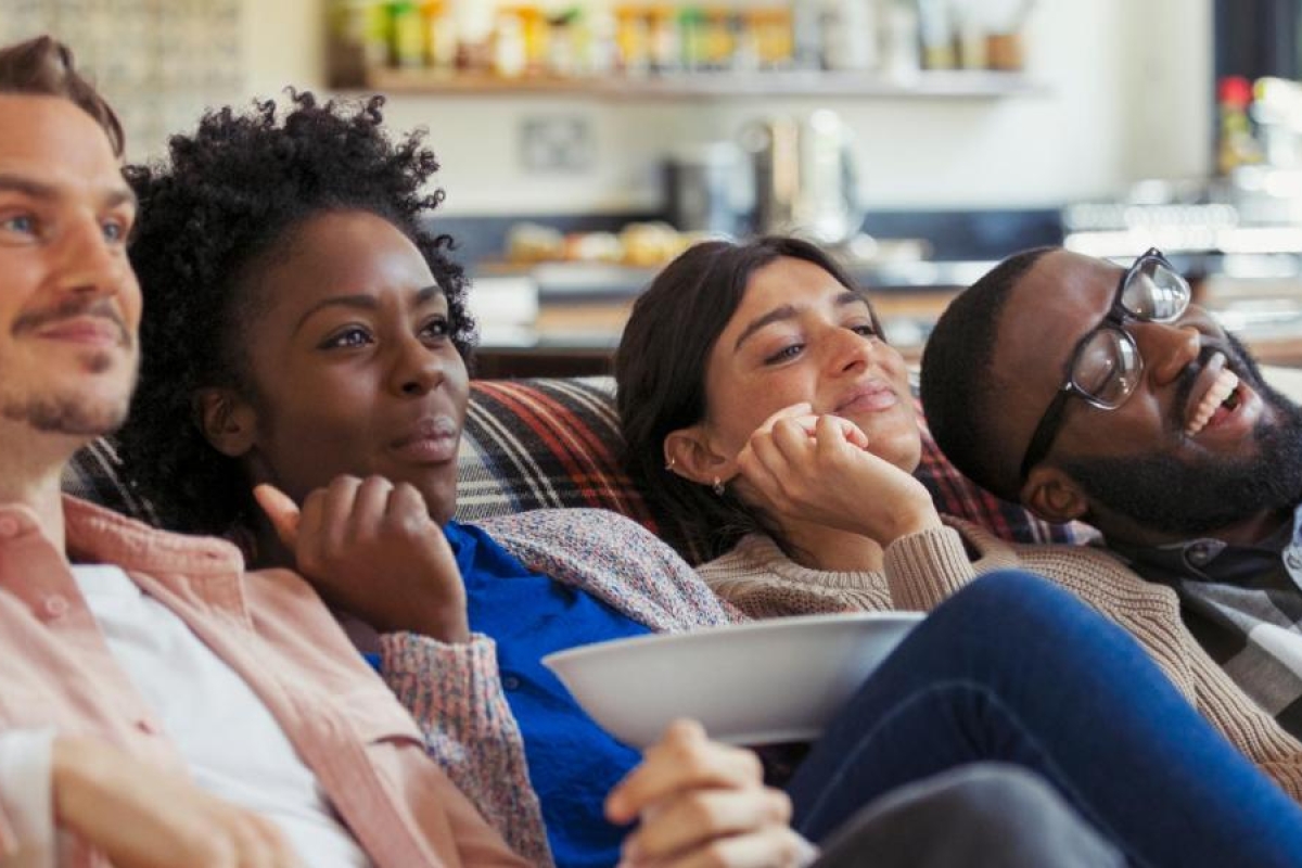 Image of a group of friends having fun watching TV.