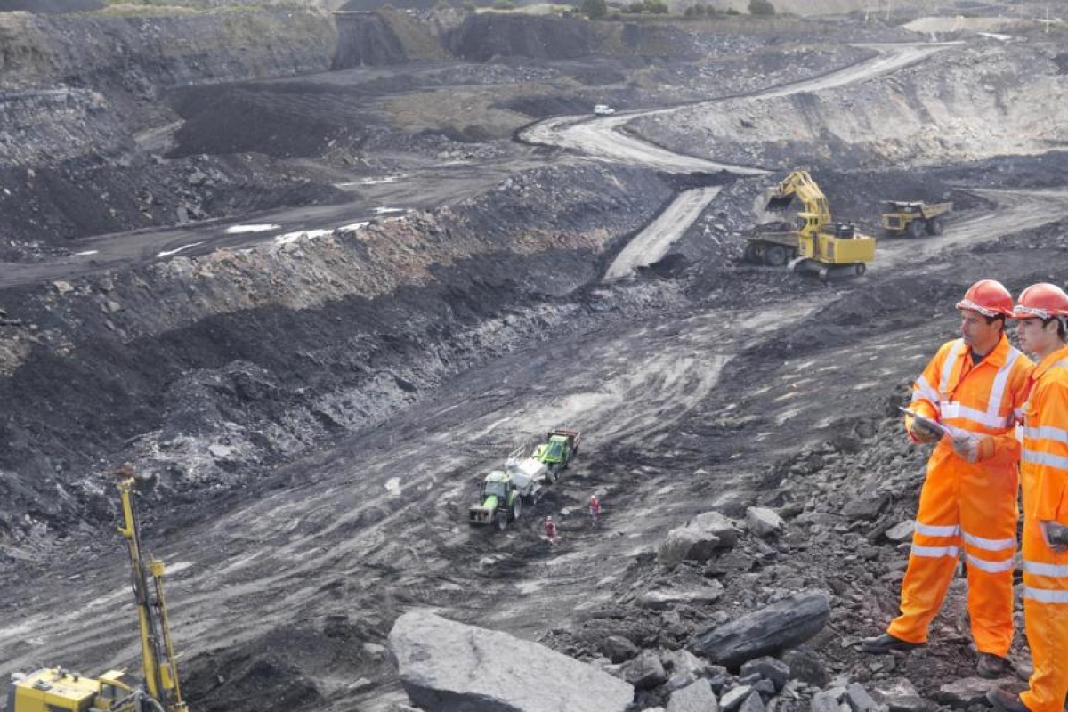 Image of two workers in a mining field.