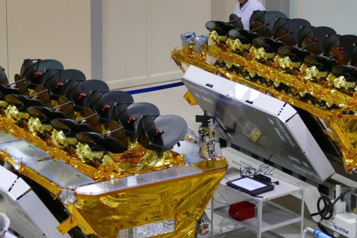 Image of two O3b satellites in a cleanroom with gold insulation.