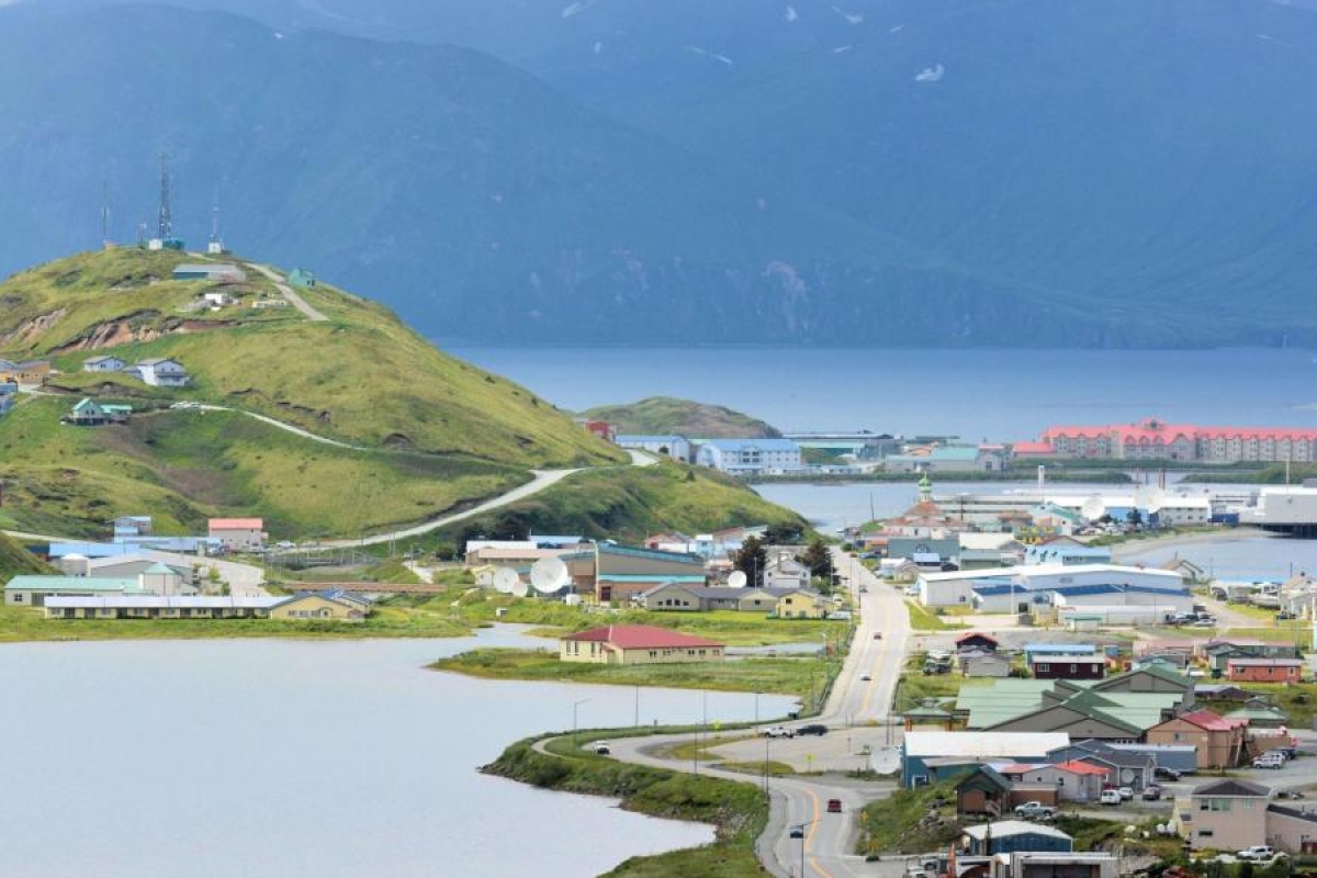 Image of a coastal town surrounded by hills and water.