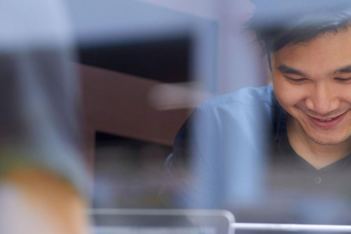 Image of a person happily using a device.