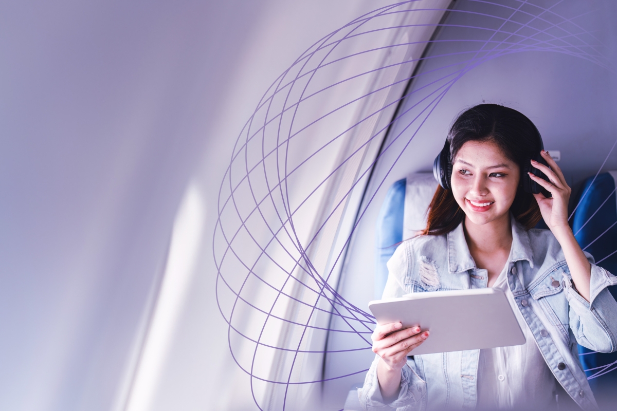 woman with headphones on airplane
