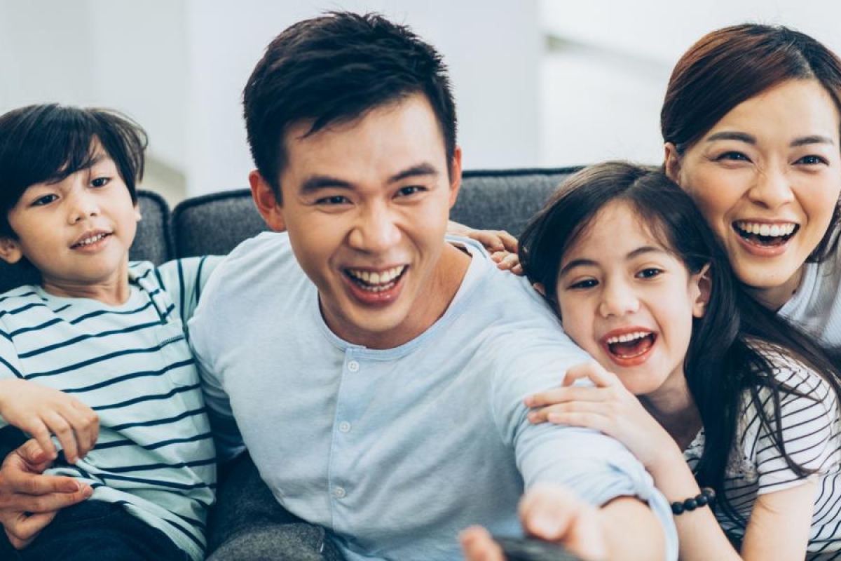 Image of a family on the couch enjoying television.
