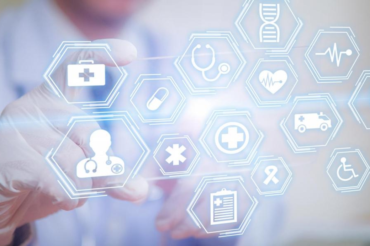 Image of a medical professional interacting with glowing digital health icons.