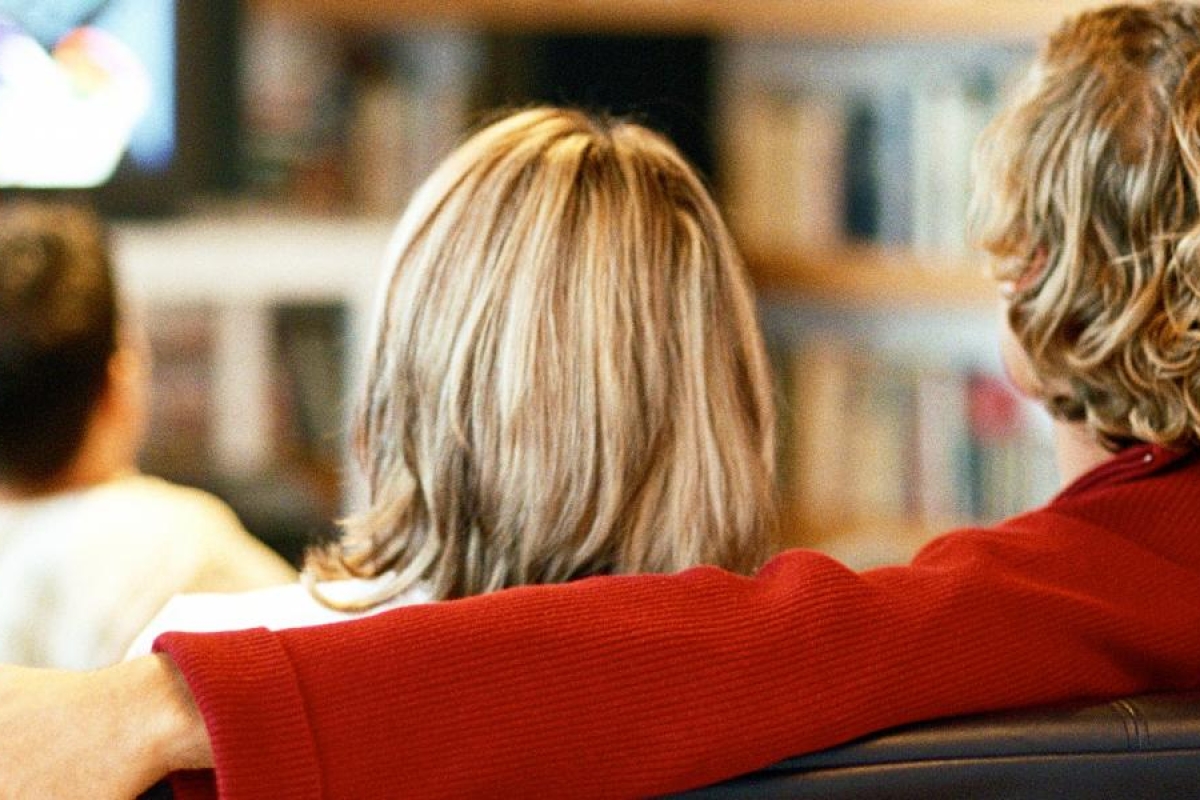Image of people sitting together watching television.