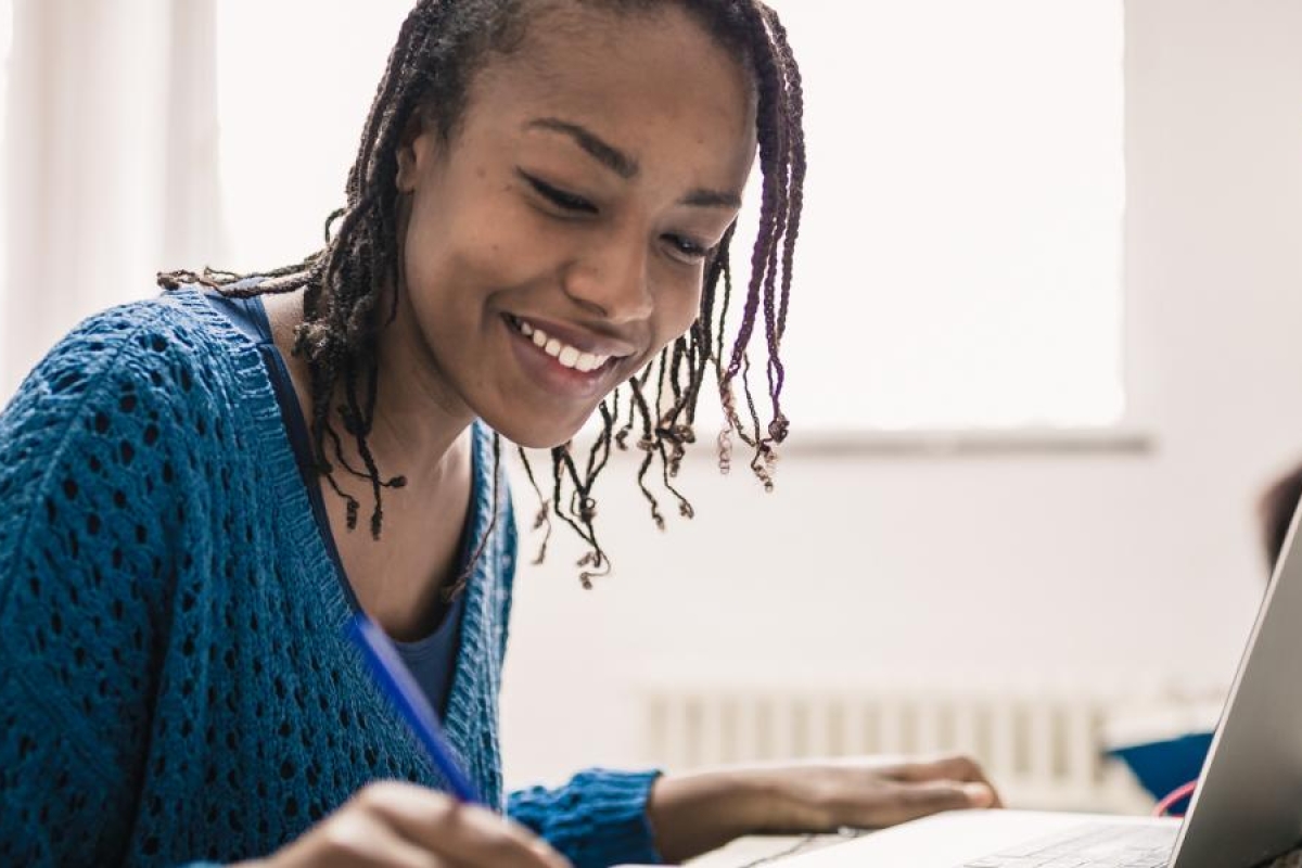 Image of person using laptop and learning.