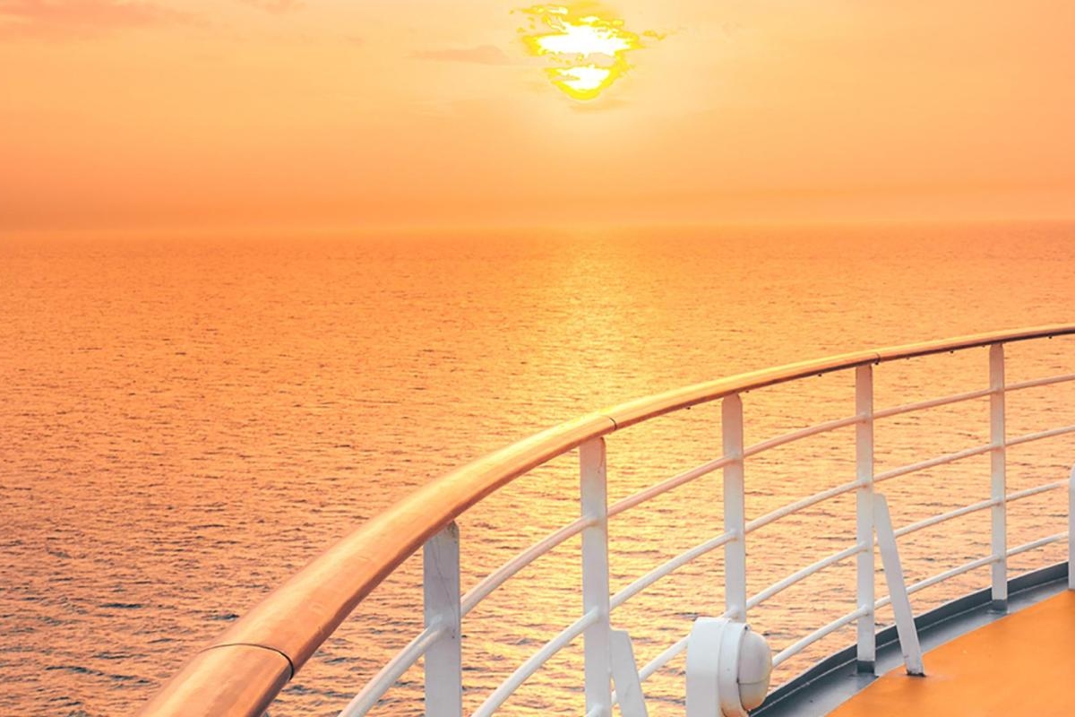 Image of an orange sunset from a ship's deck.