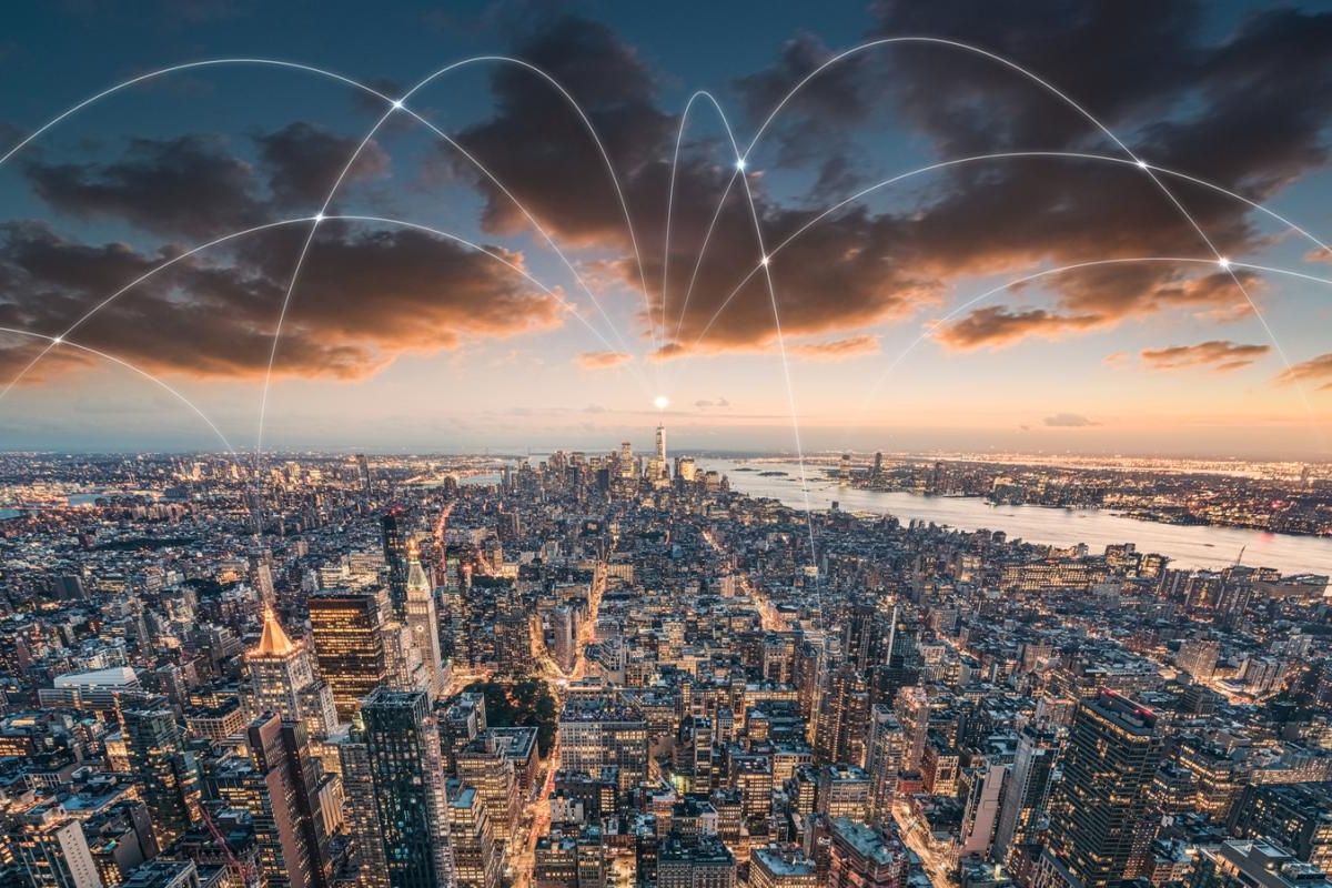 Image of city skyline with glowing network arcs across buildings.