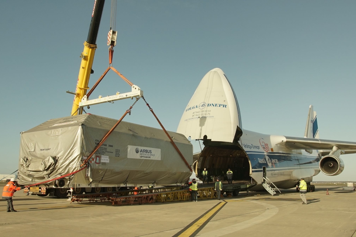 covered satellite being transported inside aircraft