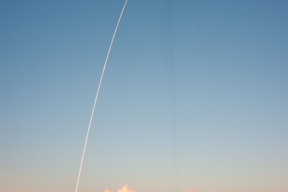 arc trajectory of rocket launch through the sky
