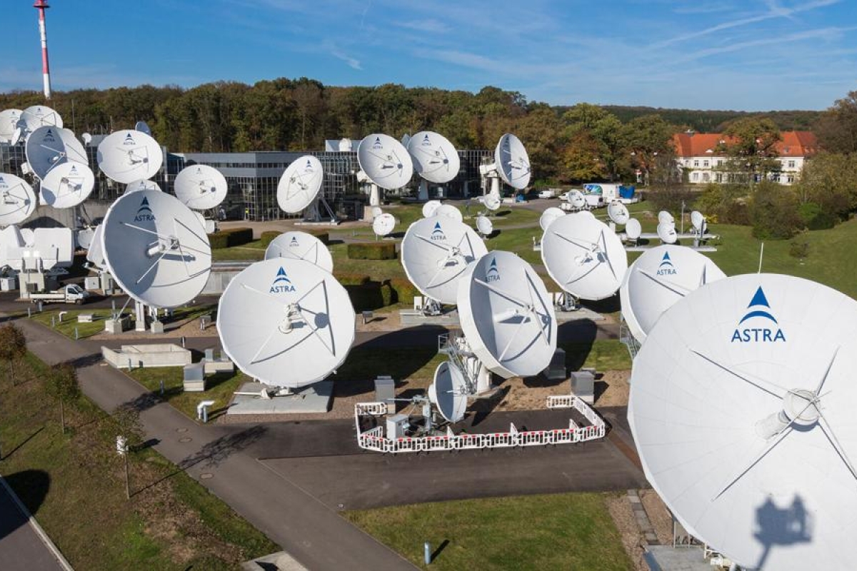 Image of a couple of SES and Astra satellite dishes in a field.