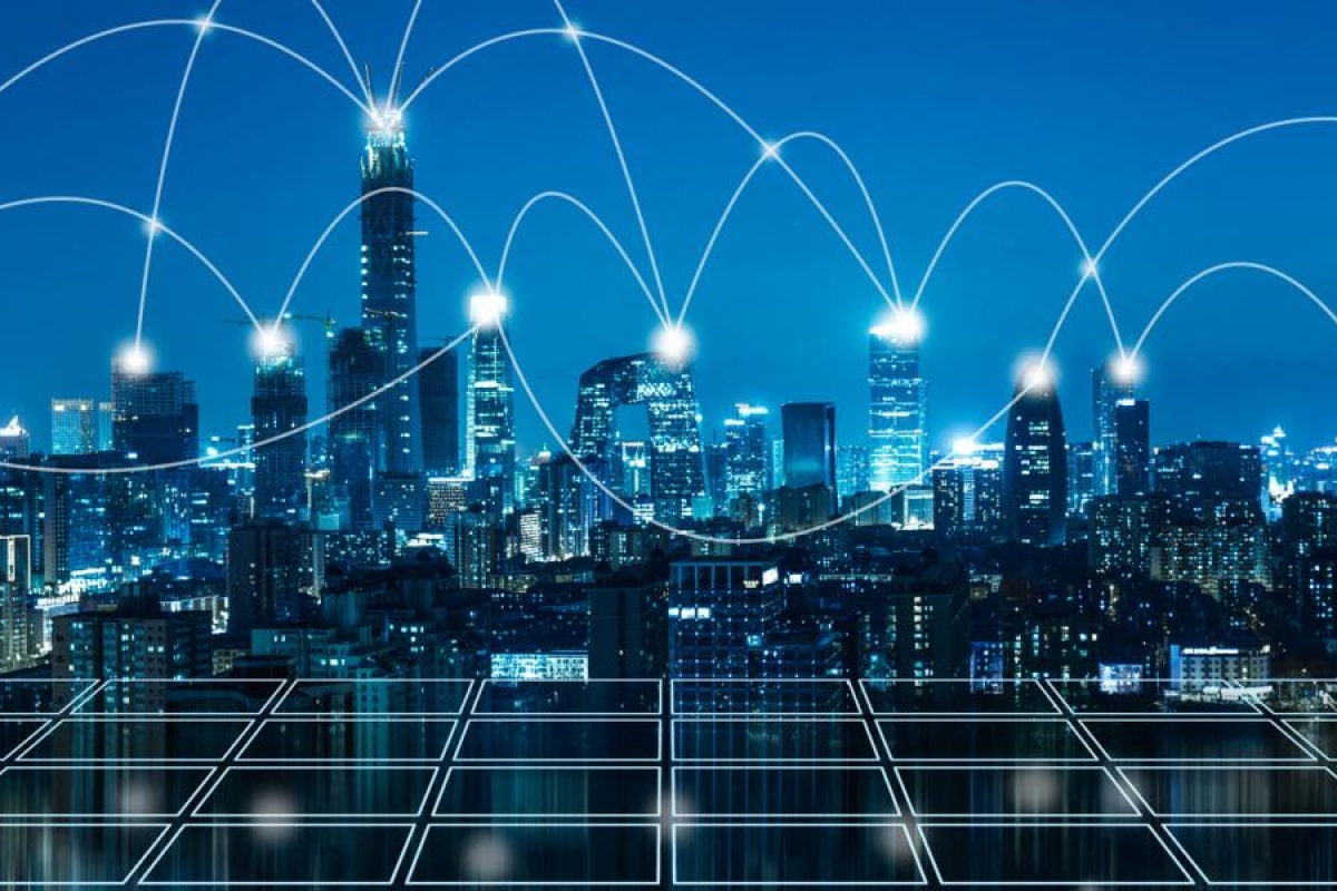 Image of city skyline at night with glowing network lines across the buildings.