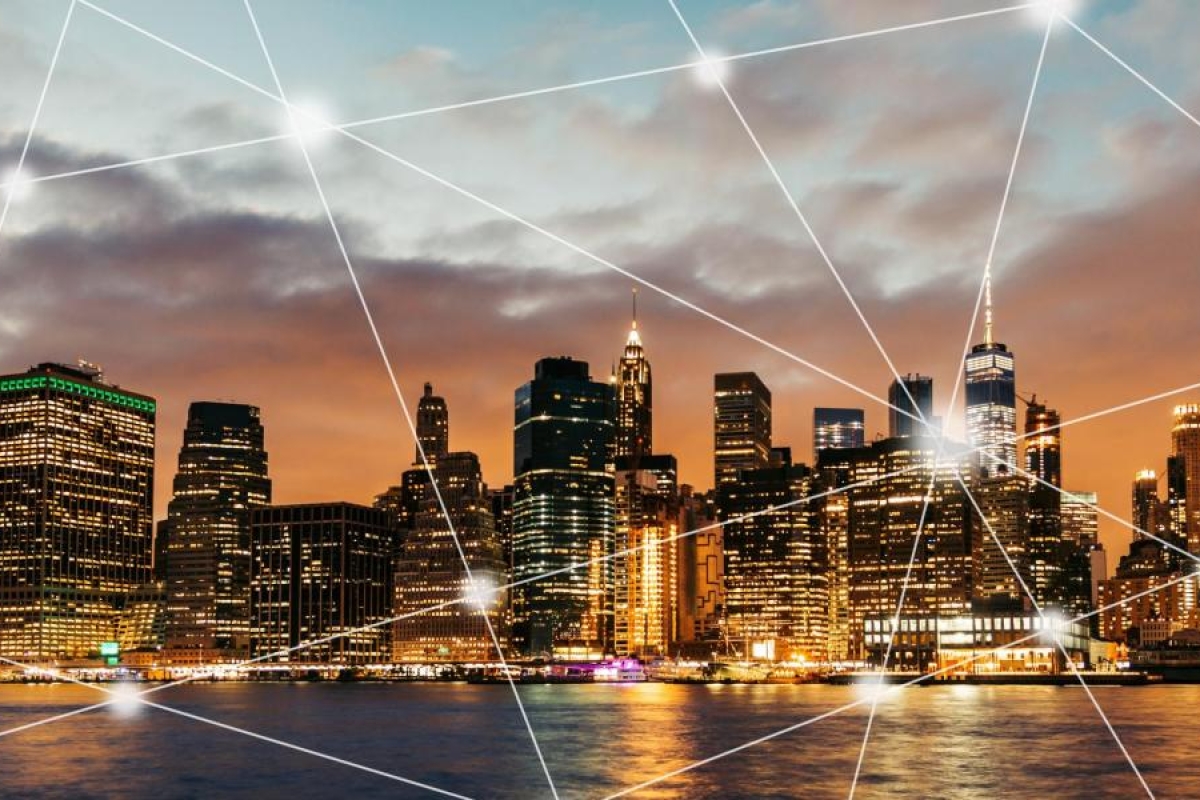 City skyline with glowing network lines connecting across the image.