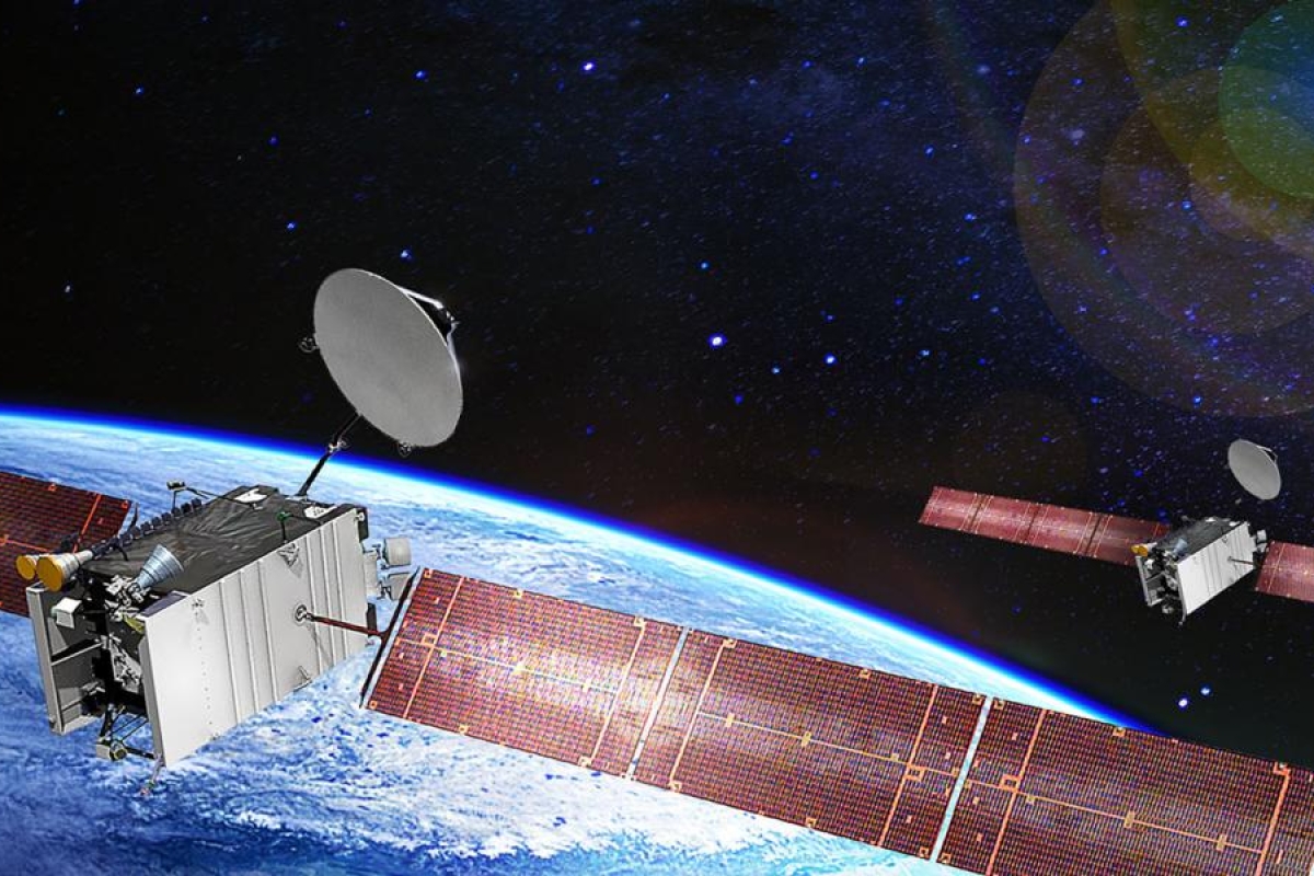 Image of two satellites orbiting above Earth against a starry space background.