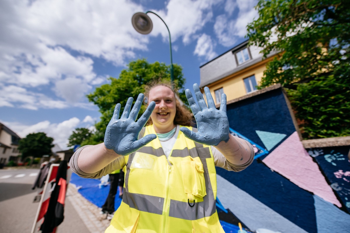 person with two hands painted in blue