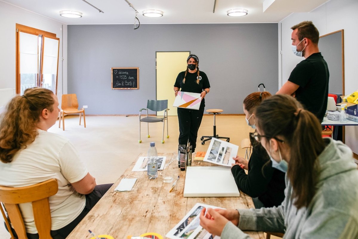 people discussing painting designs