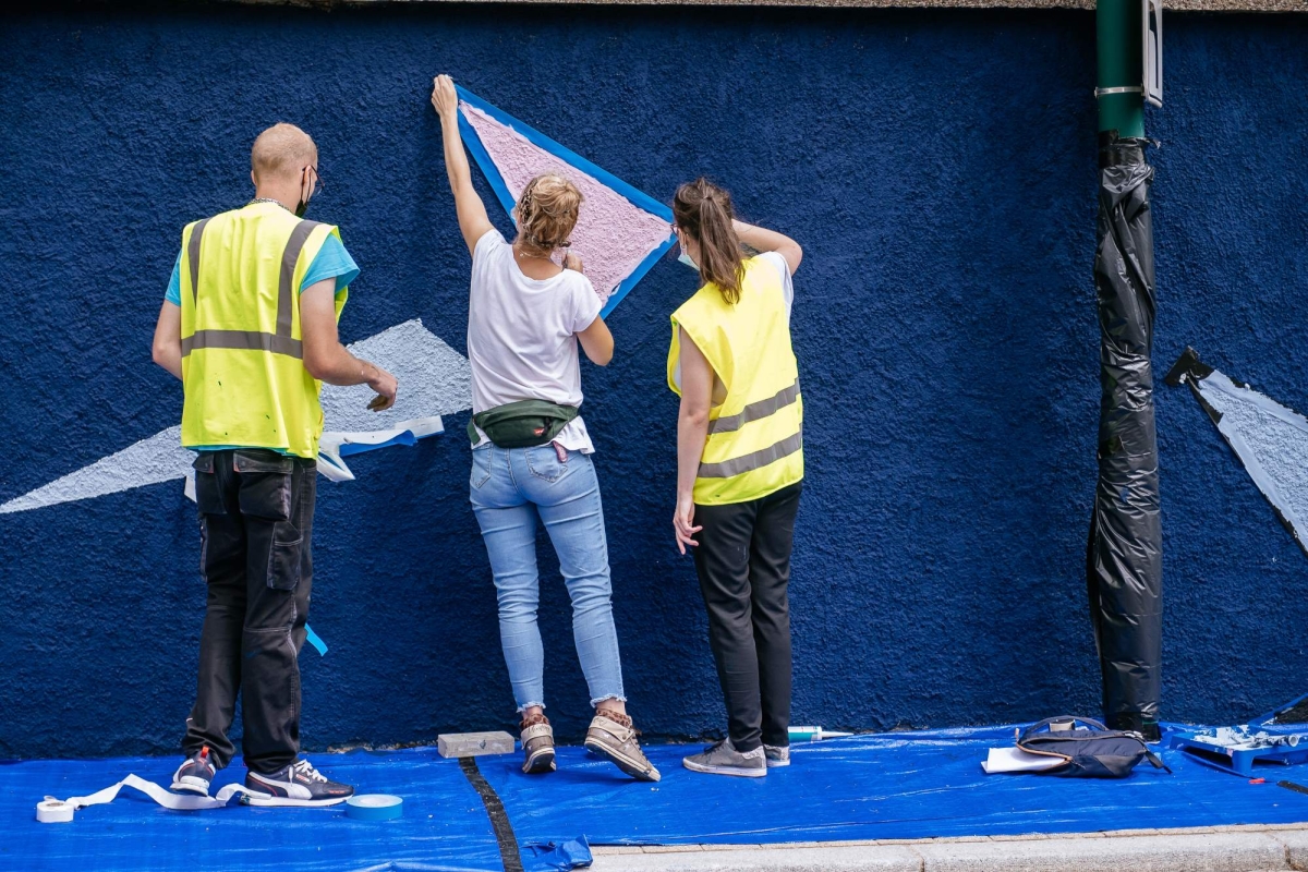 poeple painting on mural