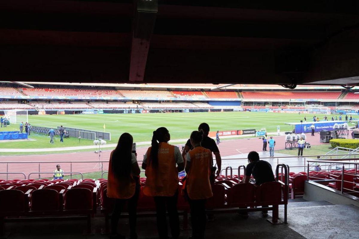 Image of stadium staff looking toward the field during an event setup.