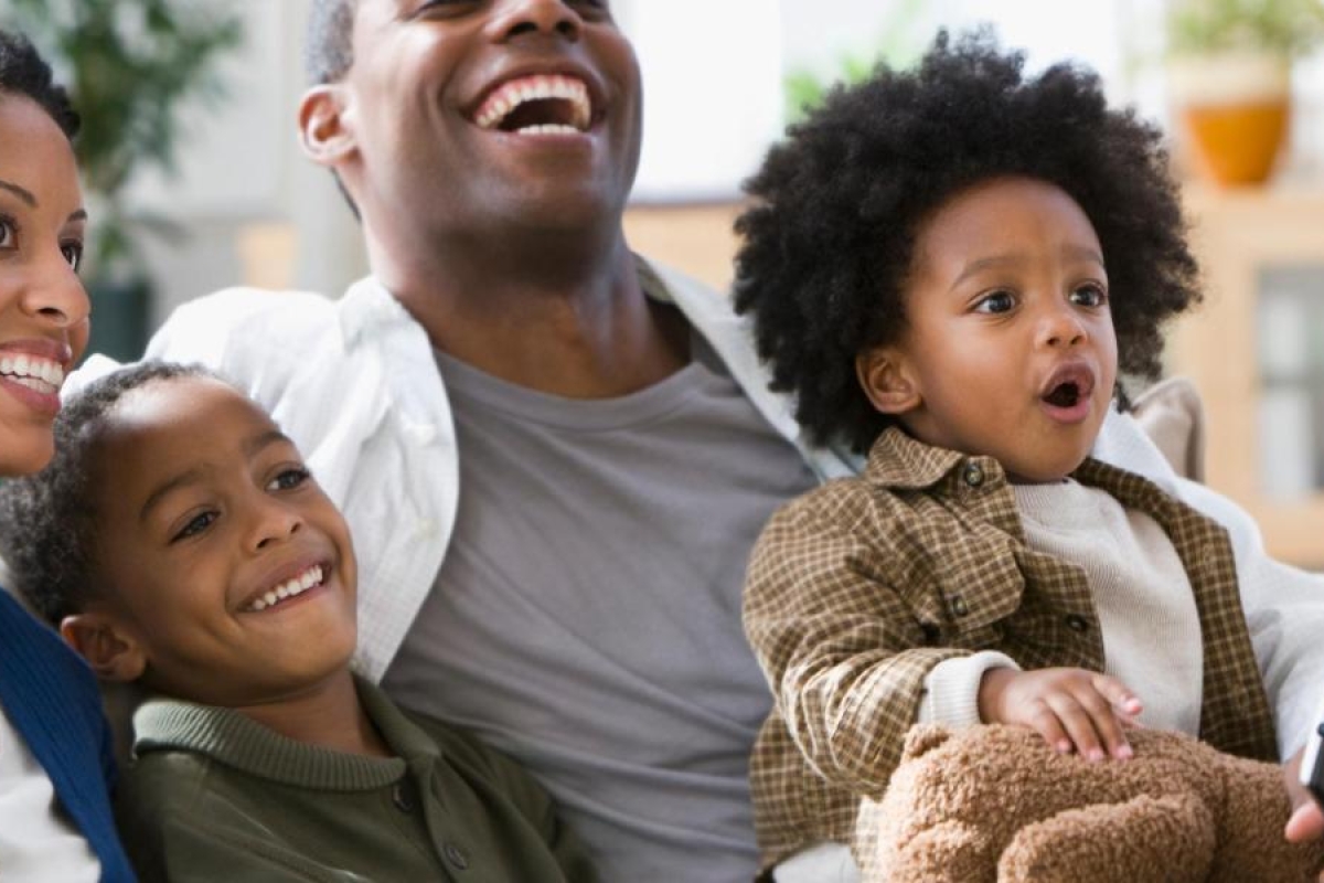 Image of a family sitting together on a couch.