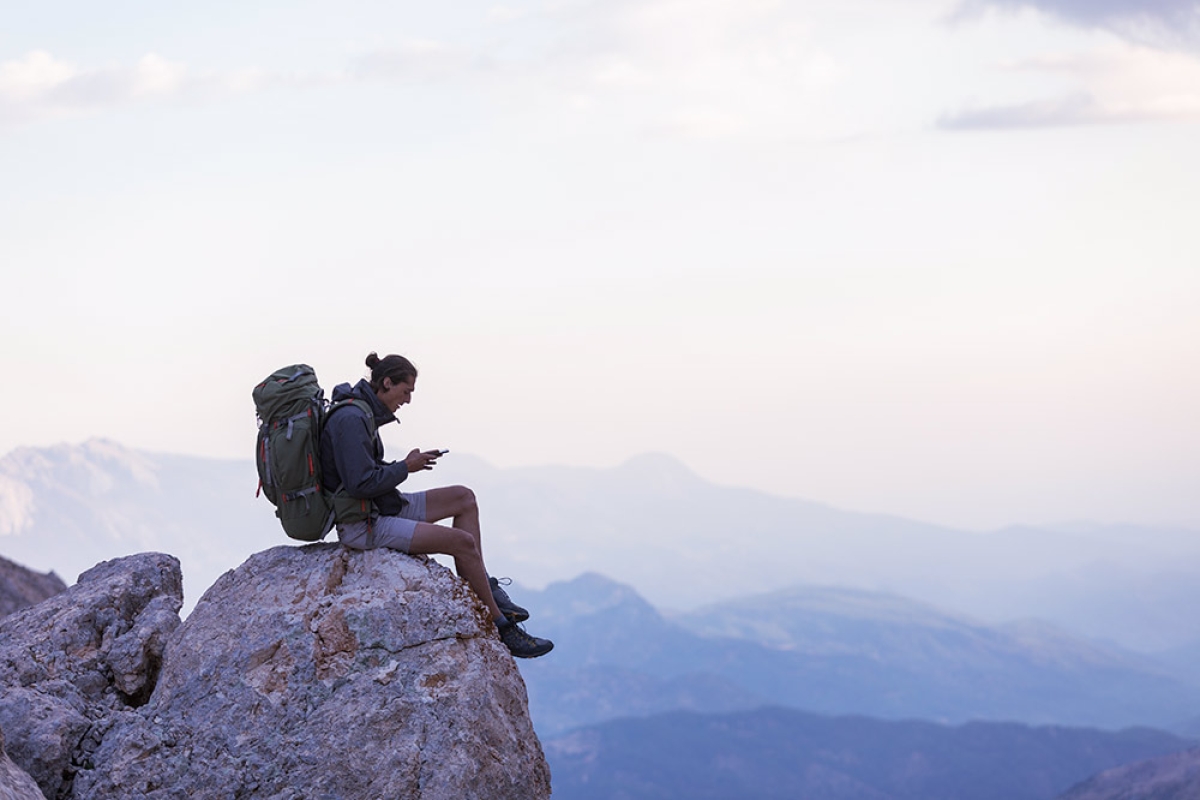 Man on mountain with mobile phone