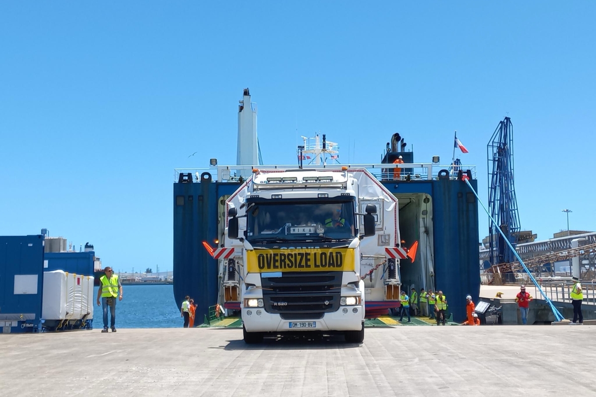 Truck being unloaded from a cargo vessel at the port.