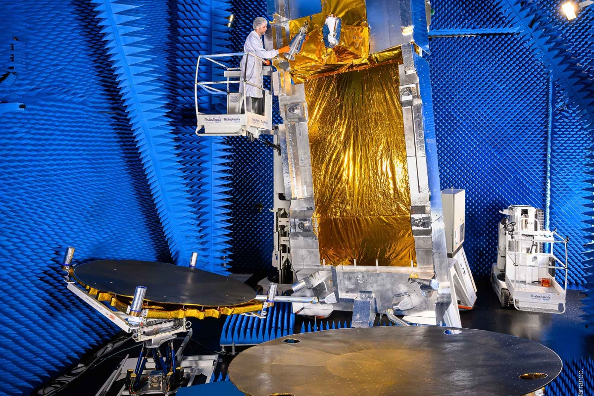 Satellite undergoing testing in an anechoic chamber.