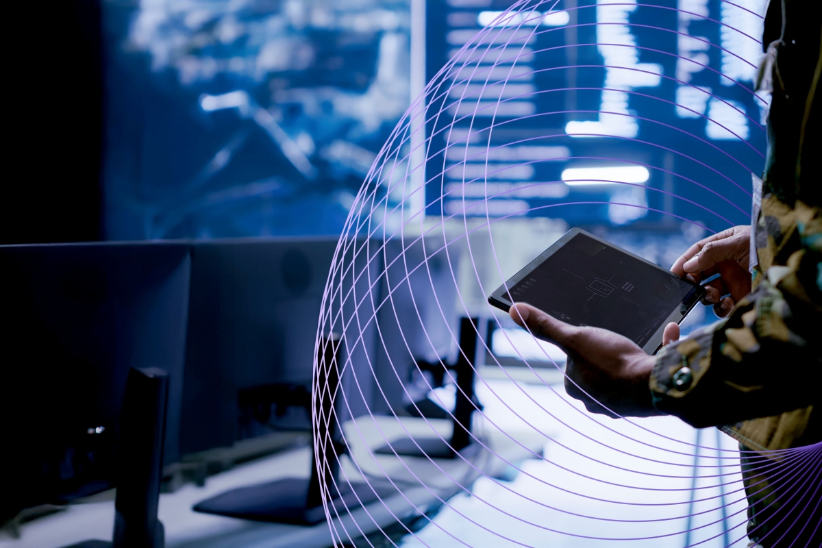military person with tablet in control room