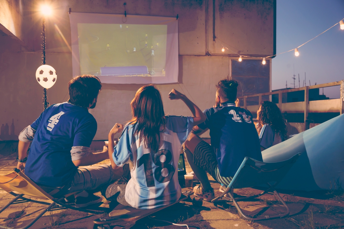 Group of people enjoying watching sports on a terrace