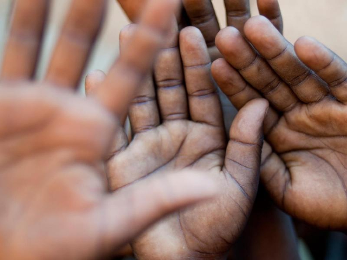 Close‑up image of children’s open palms.