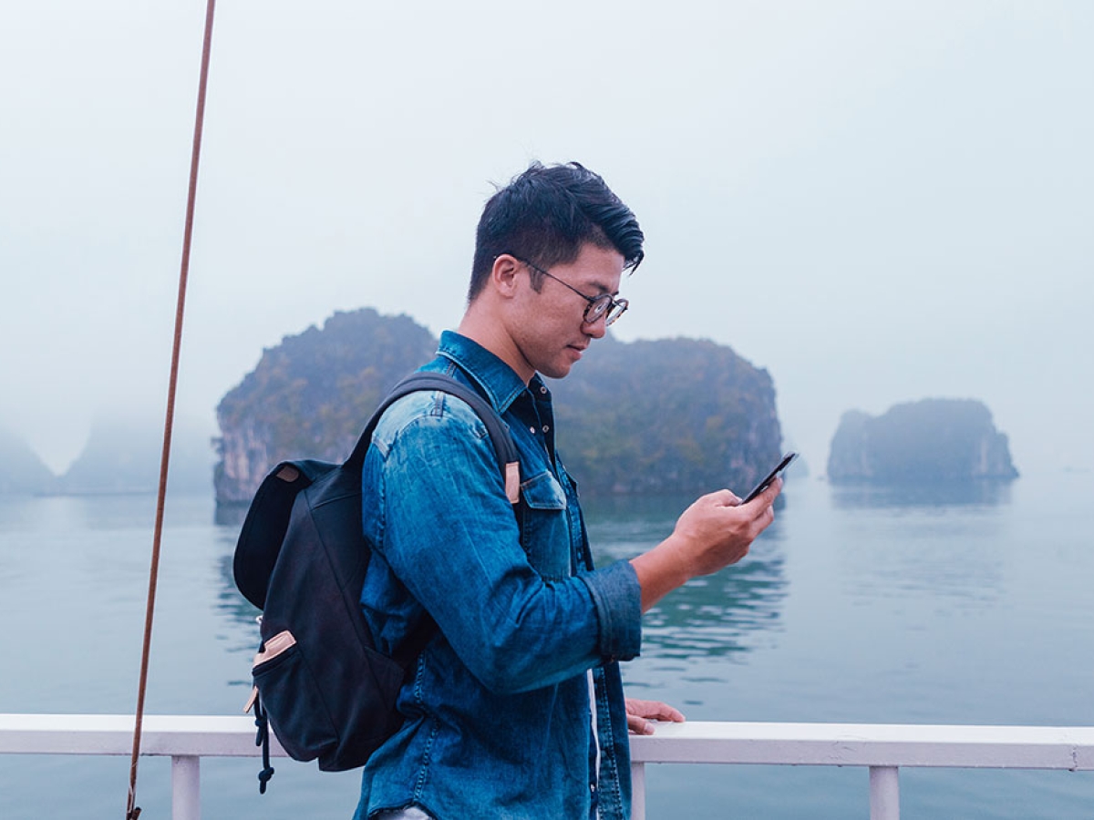 Man using mobile phone on cruise ship