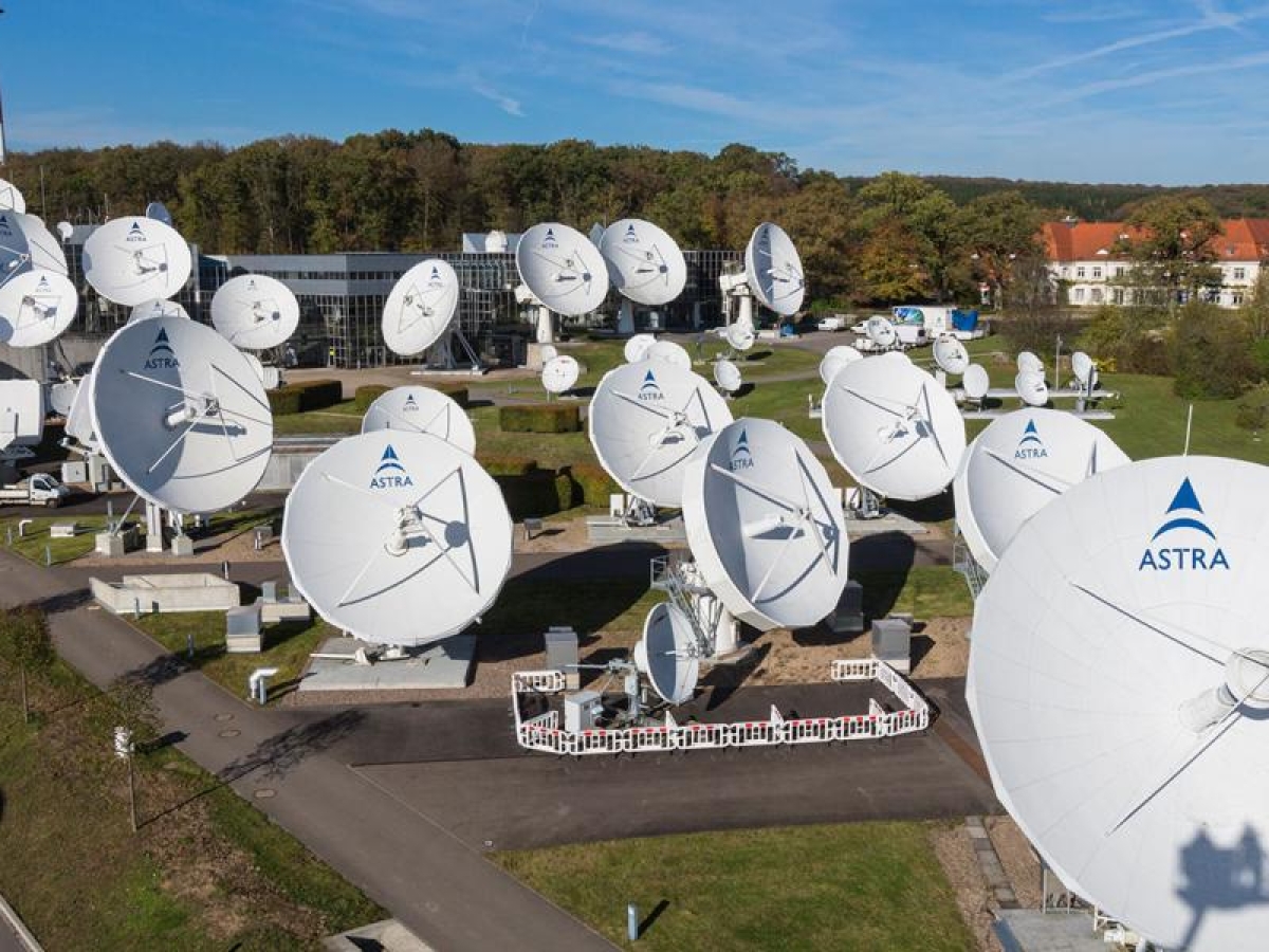 Image of large Astra antenna dishes in a field.