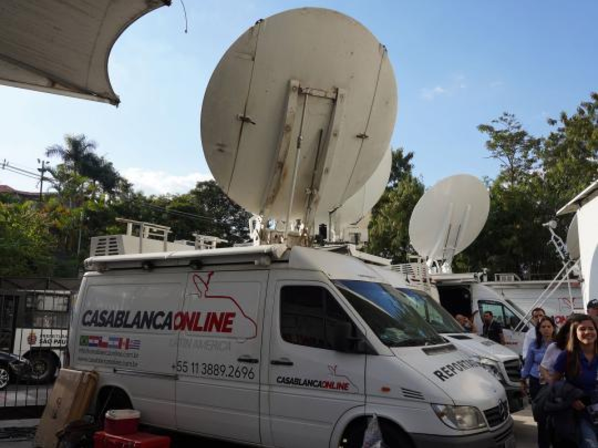 Image of media vans with large satellite dishes used for broadcast transmission