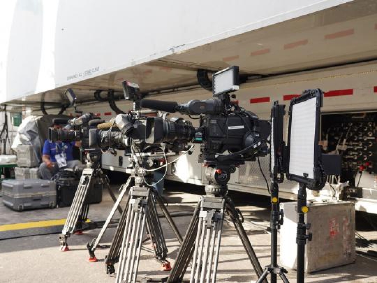 Image of professional video cameras on tripods set up for a production.