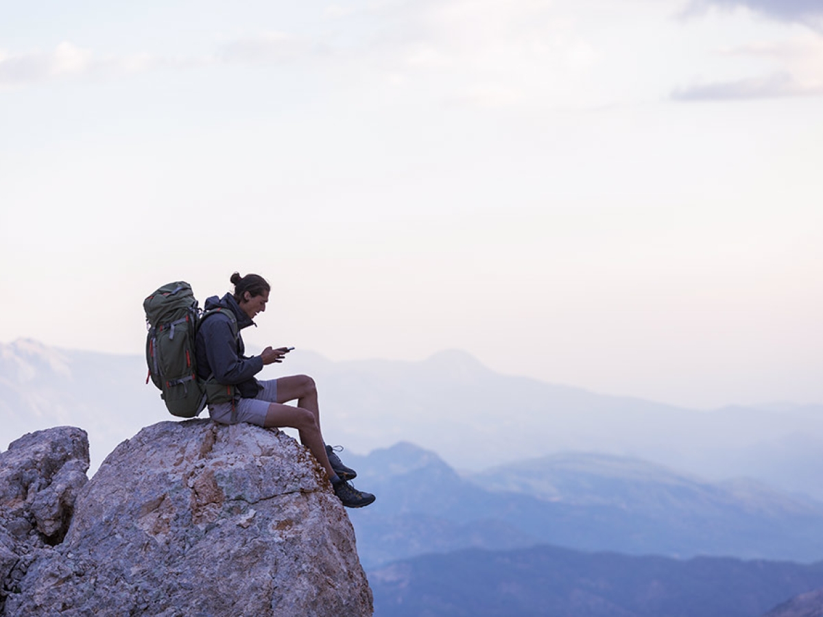 Man on mountain with mobile phone