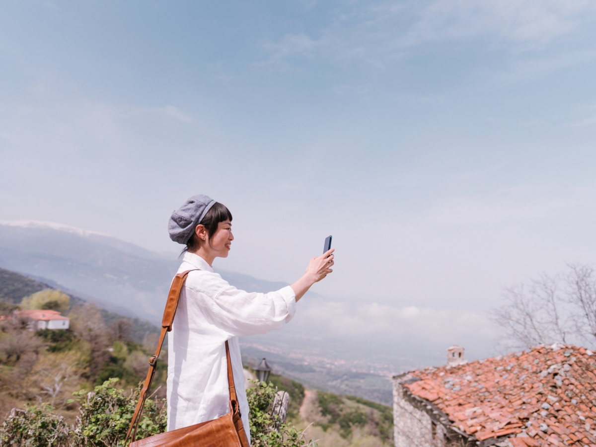 Woman with phone on Mountain