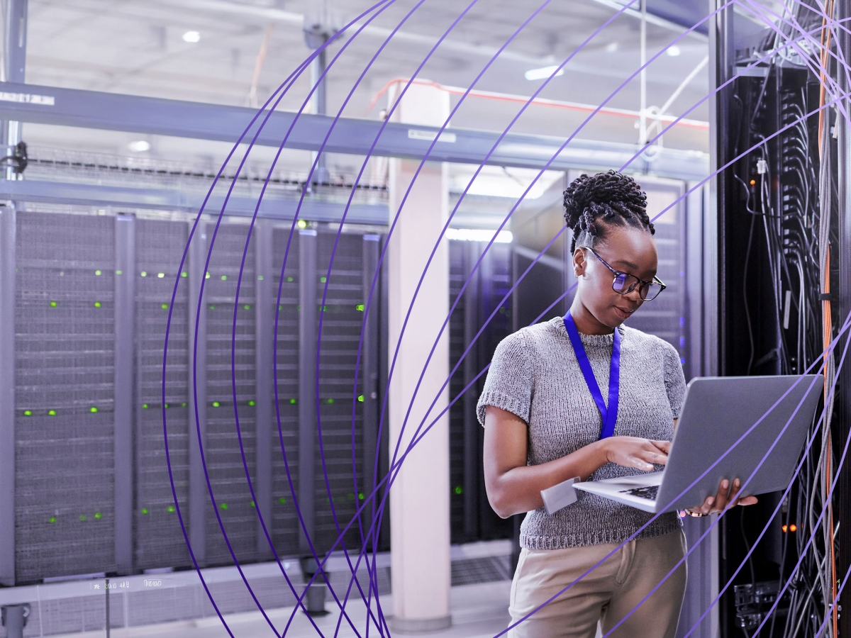 worker on laptop in server room