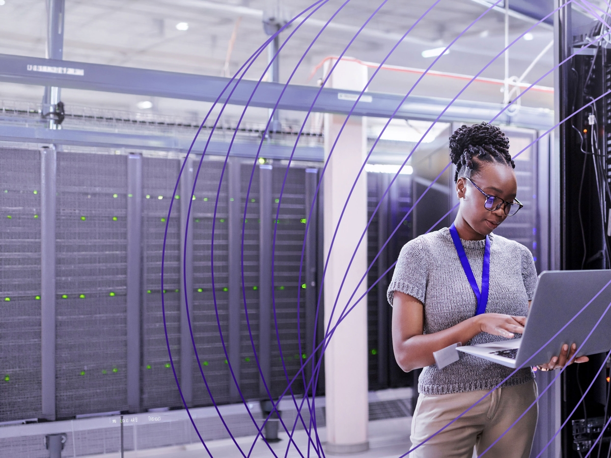worker on laptop in server room