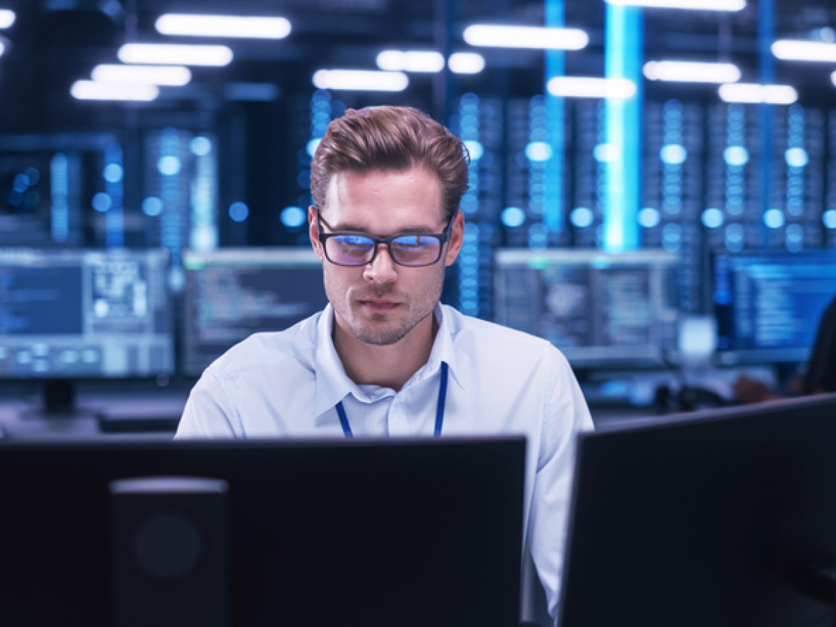 Person looking at monitors in a cloud facility
