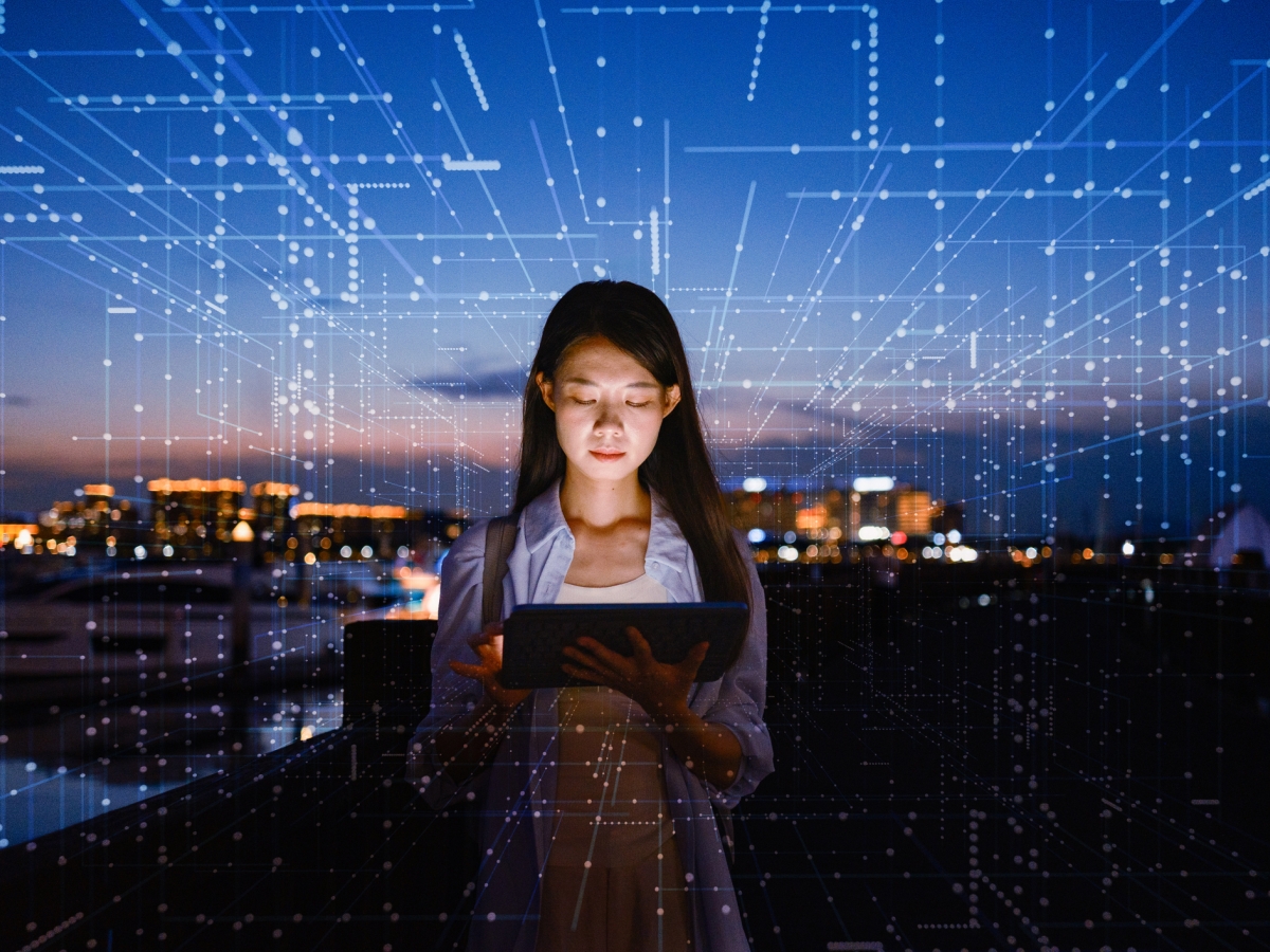Image of a person using a tablet amid a secure digital network.